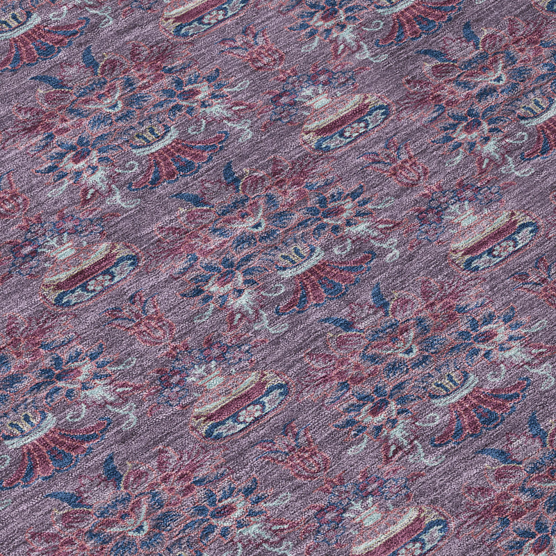 Close-up of plum and gray area rug showing ornate floral medallion details.
