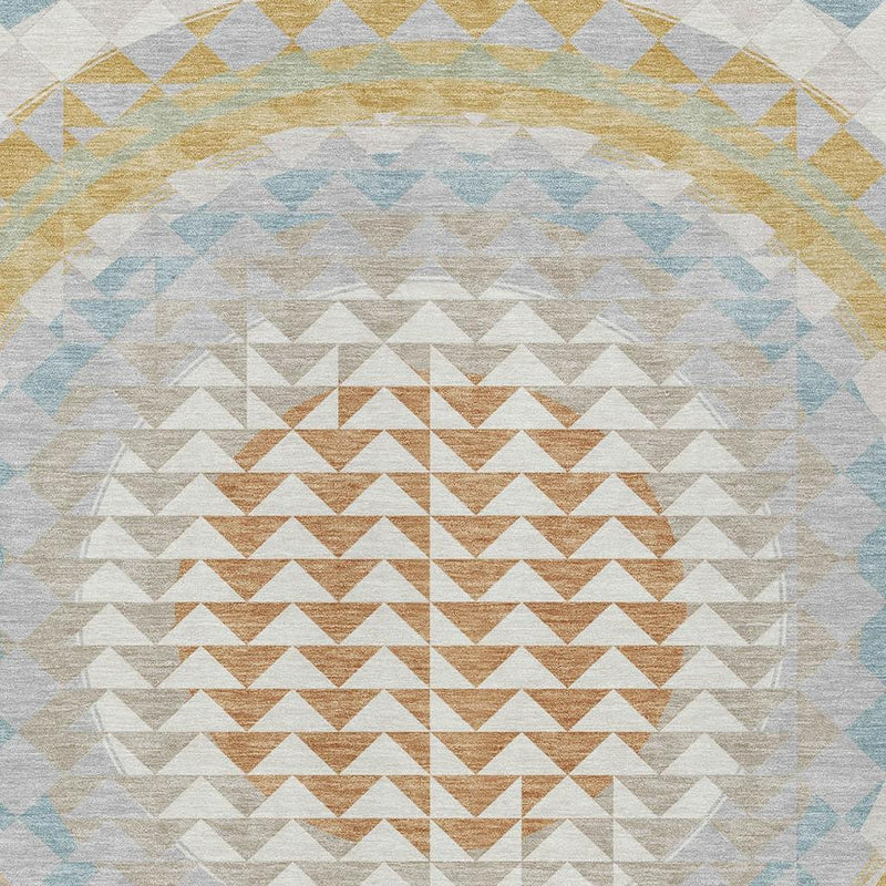 Washable area rug medallion with layered zigzag chevrons in ivory, gold, and light blue tones.