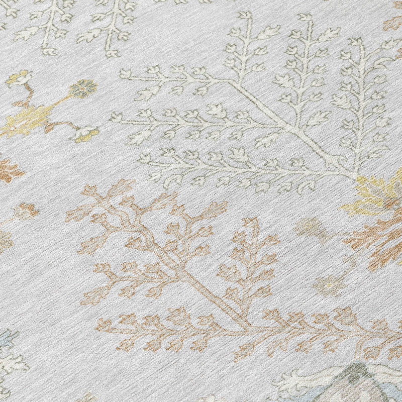 Close-up of gray rug with ivory, gold, and green-toned embroidered-style floral motif