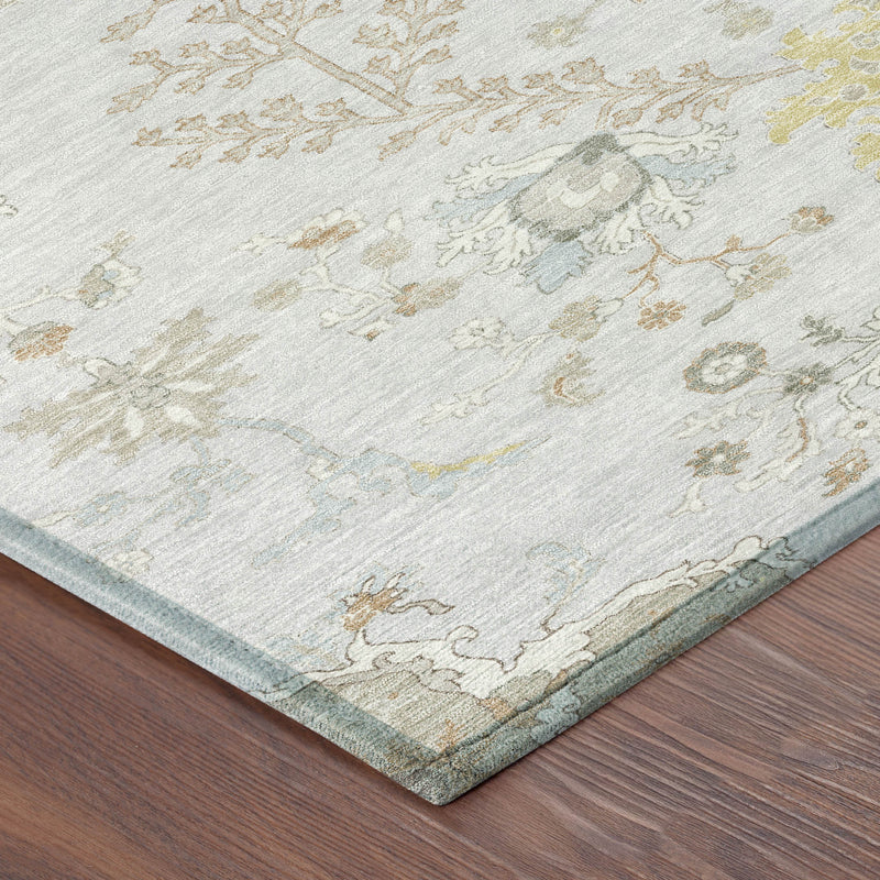 Corner view of gray area rug with ivory and muted gold floral vine pattern and bound edge