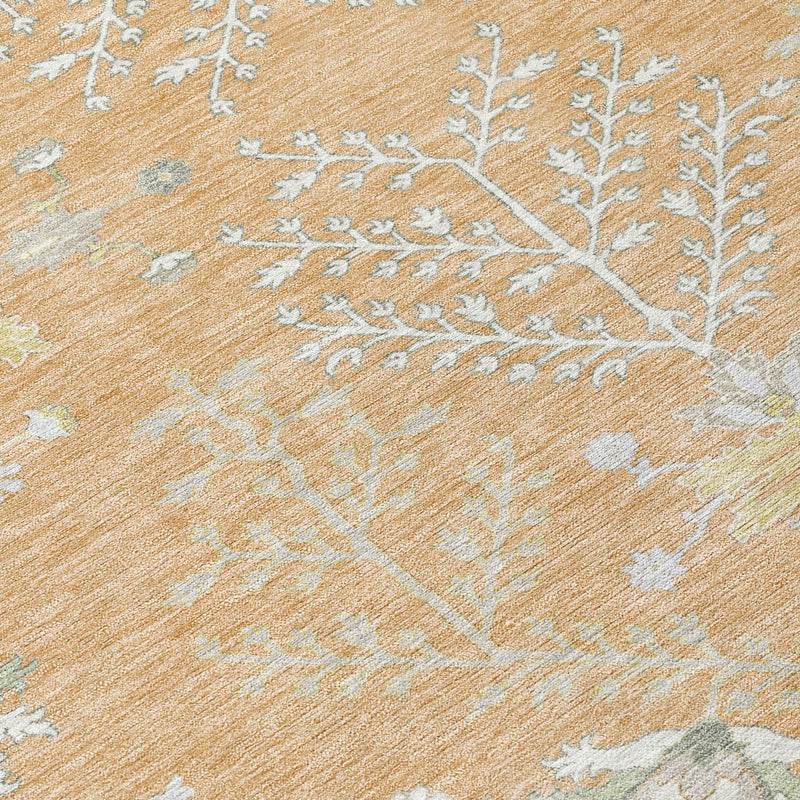 Close-up of peach and ivory oriental rug texture with light blue floral branch pattern