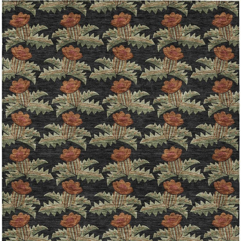 Floral area rug close-up with dark background, rust flowers, and green vine motifs