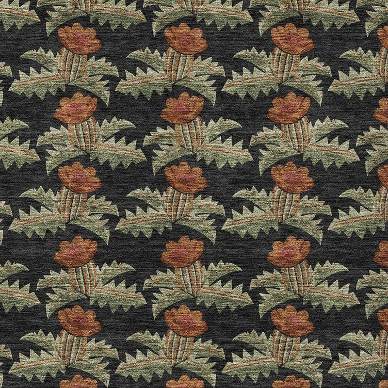 Floral area rug pattern detail with rust blooms and green leaf shapes on dark ground