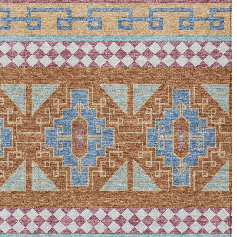 Geometric tribal area rug close-up with tan field, blue and aqua figures, and maroon diamond band