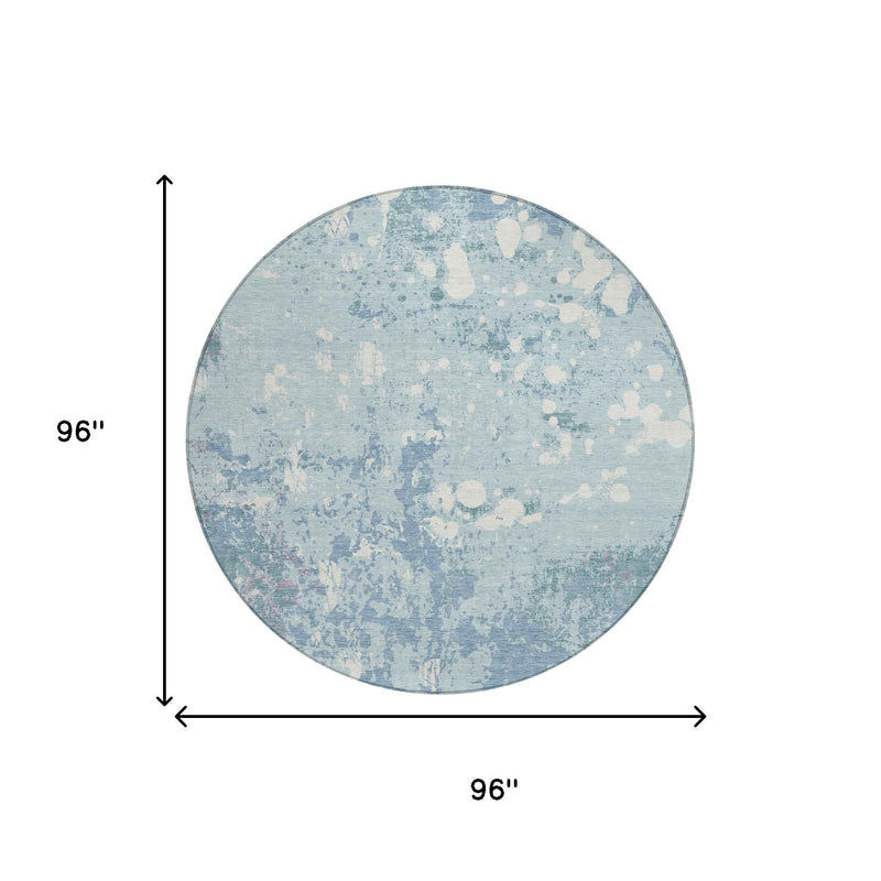 Round blue abstract area rug with beige speckled pattern and flat woven texture.