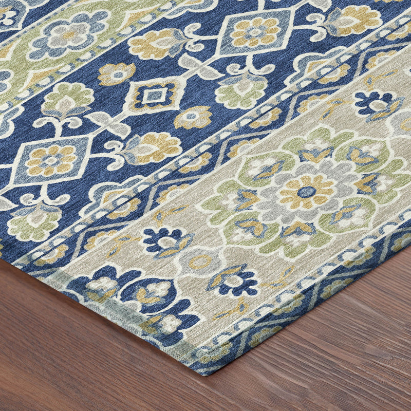 Navy and beige tribal patterned indoor outdoor area rug, corner view with floral motifs
