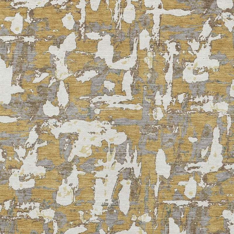 Close-up of abstract area rug pattern in gold, ivory, and gray