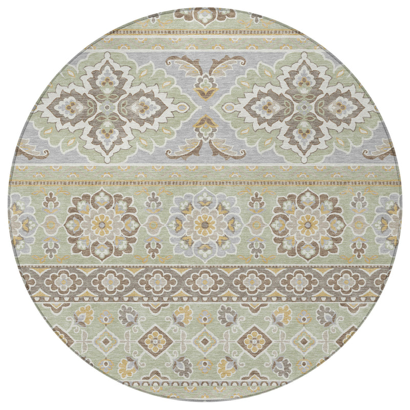Round area rug in green and ivory, featuring a centered floral tribal motif and border