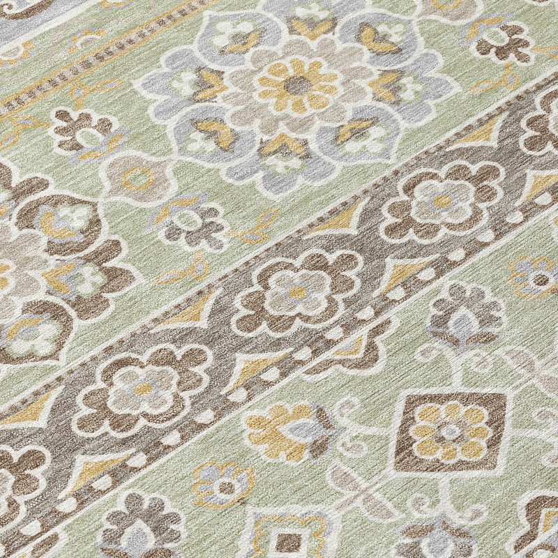 Green and ivory rug close-up with floral and geometric tribal motifs in woven texture