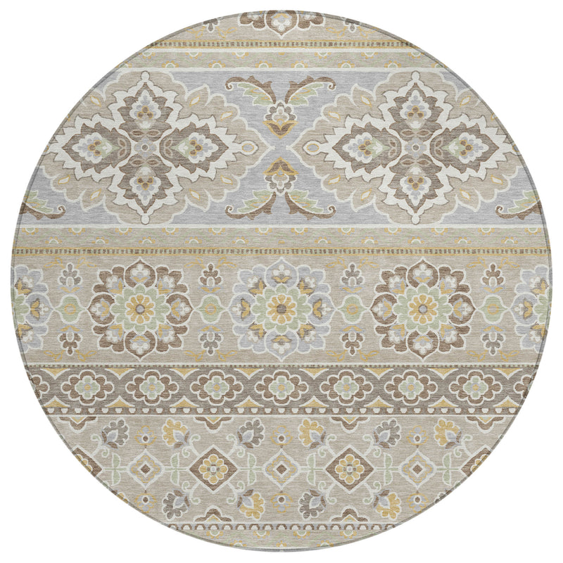 Round patterned area rug with beige/ivory ground, gray outlines, and muted green details.