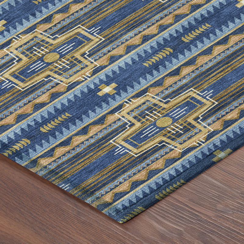 Corner of navy blue tribal area rug with woven geometric bands in tan and gold