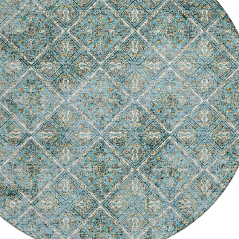 Close-up view of teal round rug showing distressed diamond medallions and speckled texture