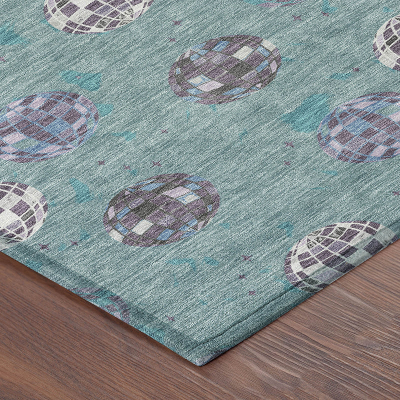Corner view of teal blue area rug with purple and white geometric orb pattern