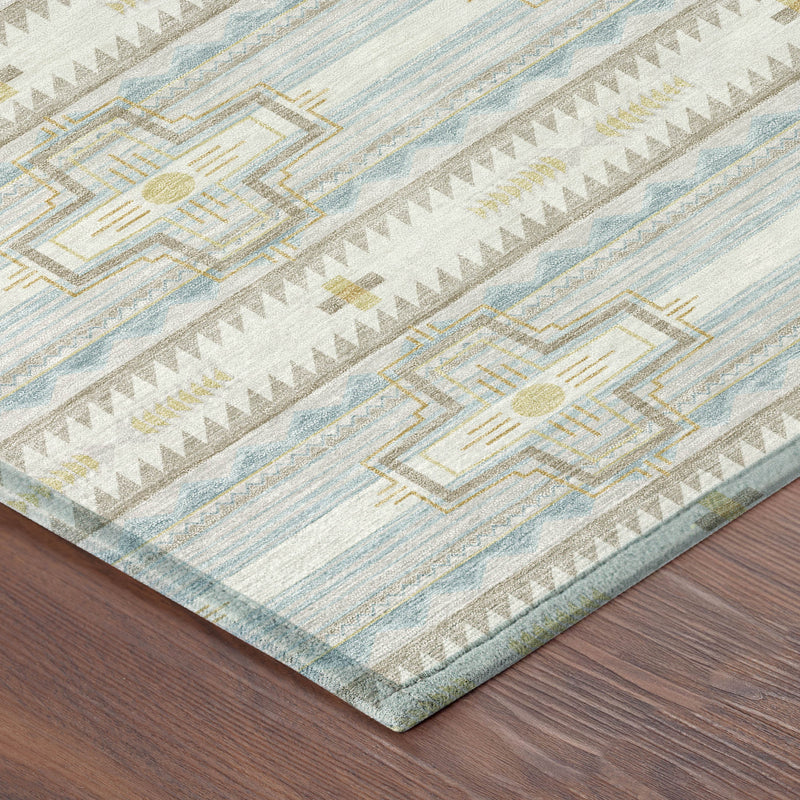 Ivory and light blue area rug corner with striped tribal cross motifs and fringe edge