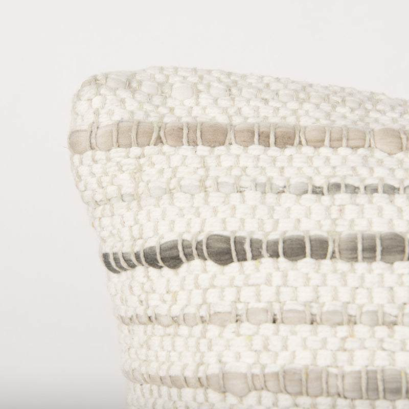 Cream and beige striped throw pillow cover corner with fabric texture details