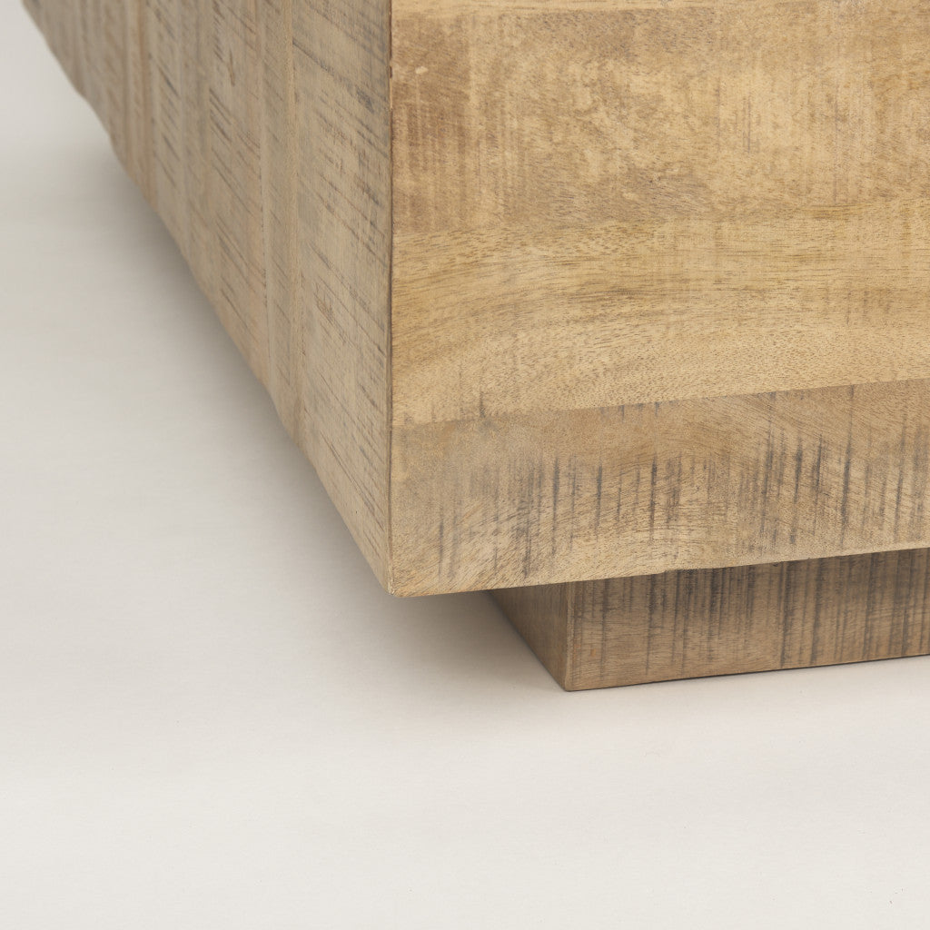 Corner detail of a light natural wood square block coffee table