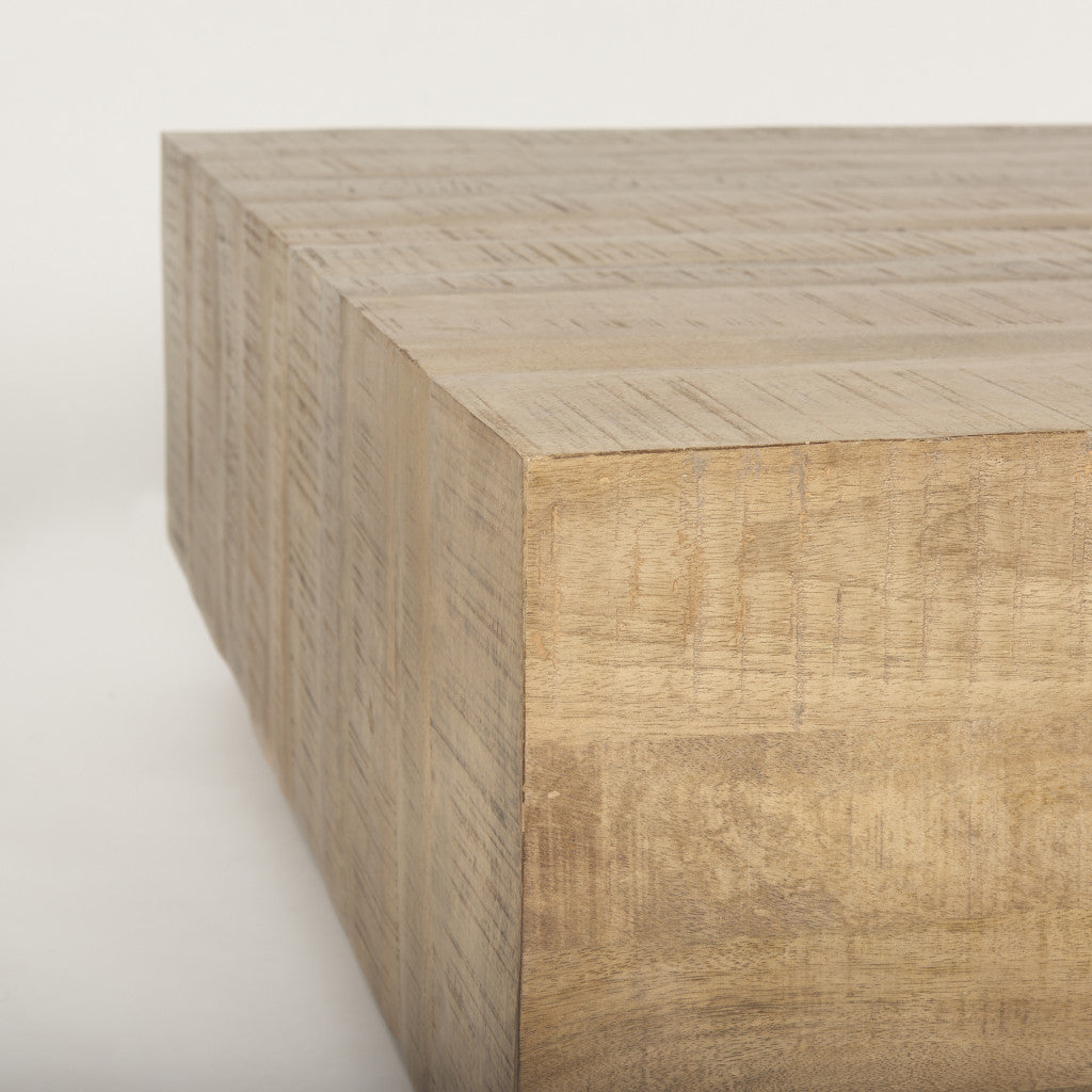 Corner view of a natural wood square block coffee table