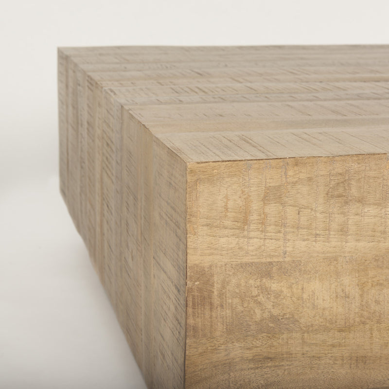 Corner view of a natural wood square block coffee table