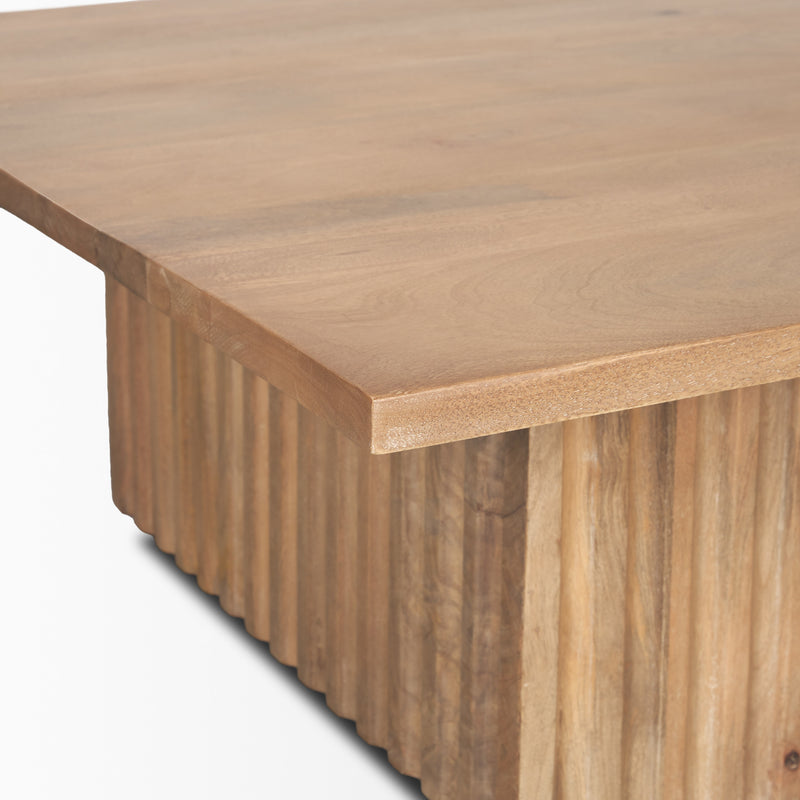 Close-up of light brown solid wood square coffee table edge with smooth tabletop