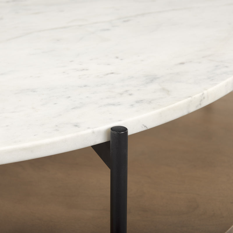 Round coffee table edge with white stone surface and dark iron support leg