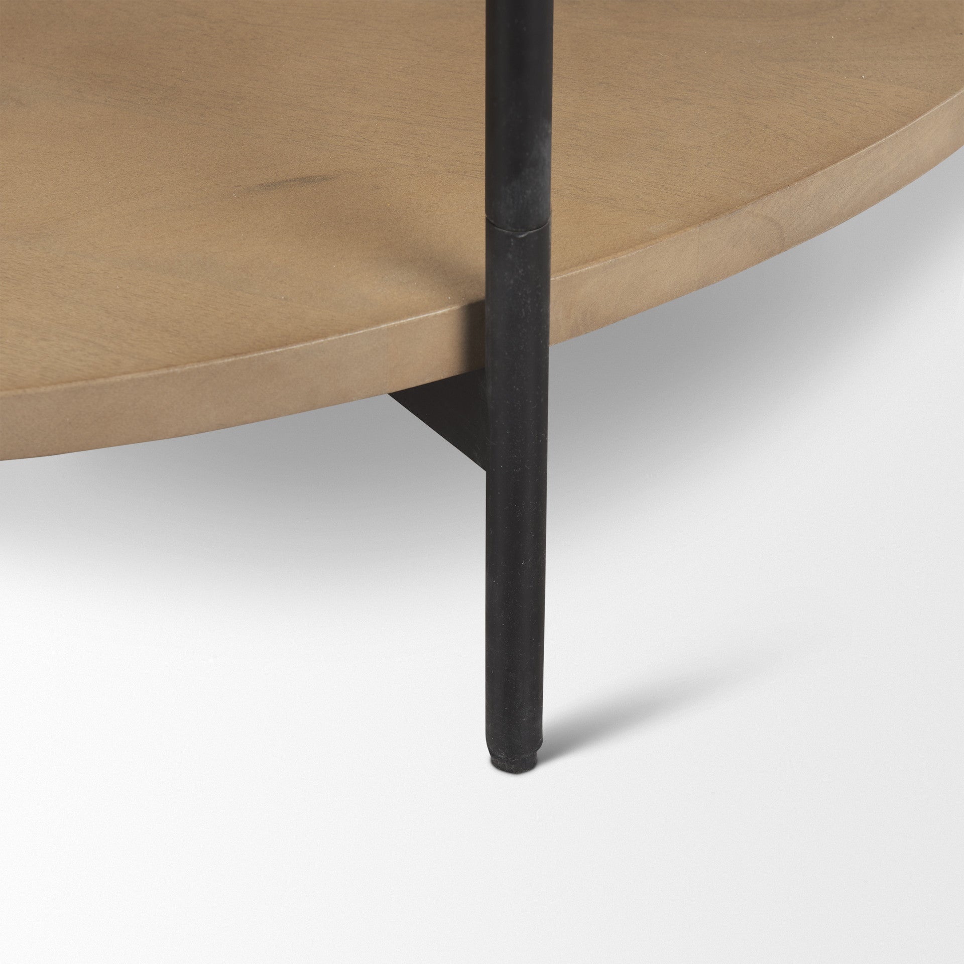 Coffee table corner close-up: brown wood shelf with dark iron leg and white stone edge