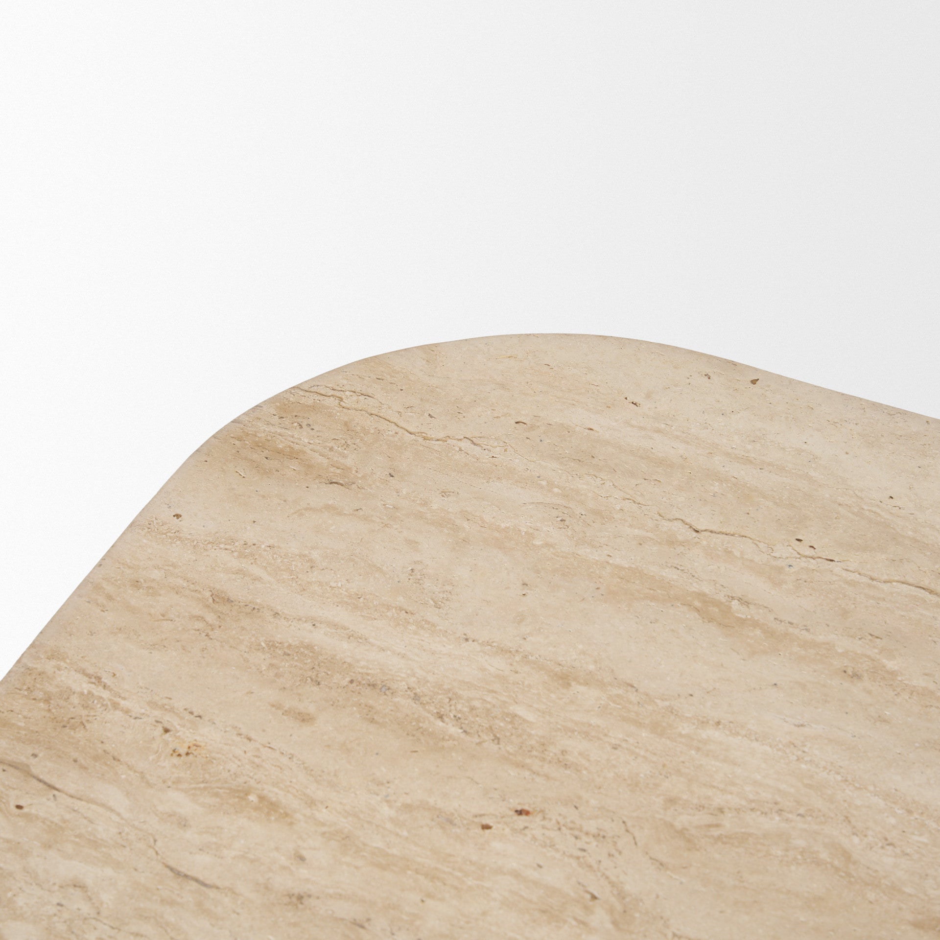 Round beige stone coffee table top with natural veining and speckled finish