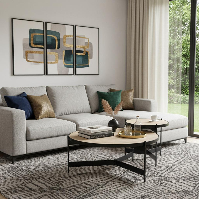 Round nested coffee tables with beige stone-look tops and black iron legs