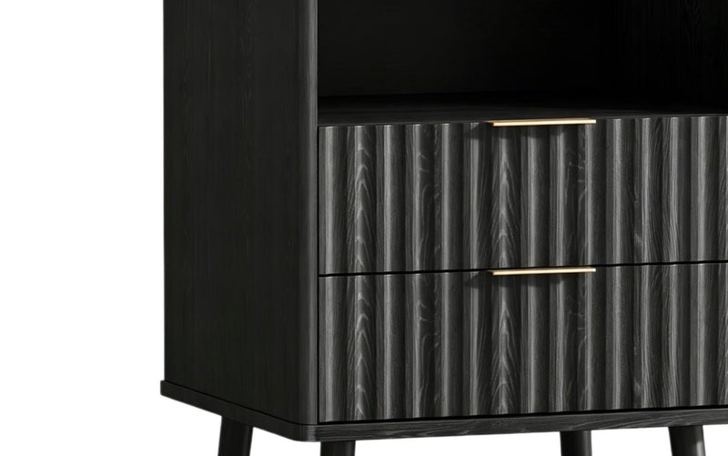 Black nightstand drawer front with vertical ribbed panels and gold bar pull