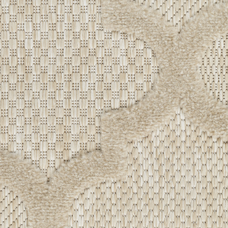Close-up of woven trellis rug texture with cream-and-beige pattern sections