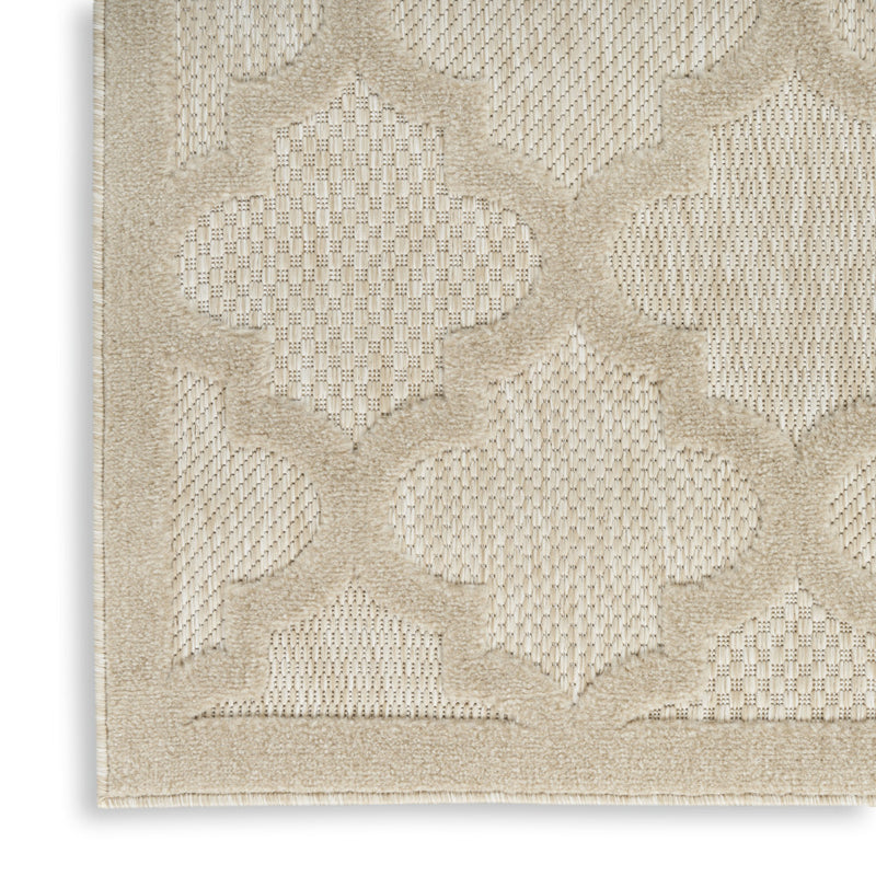 Cream and beige trellis area rug with quatrefoil pattern and frayed edges
