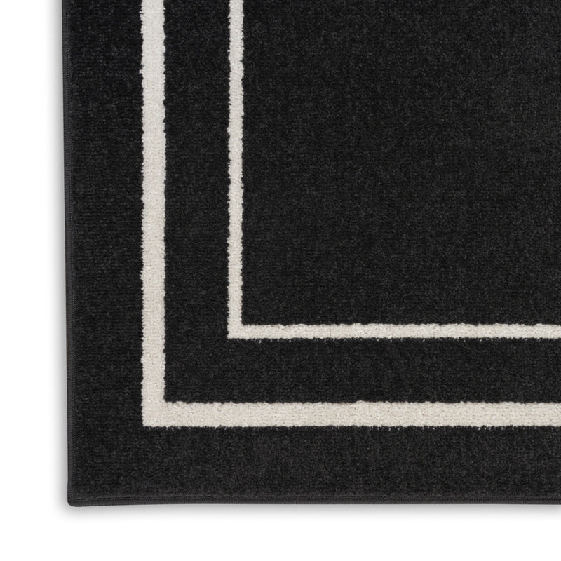 Black rug corner with ivory outline lines and thick border detail