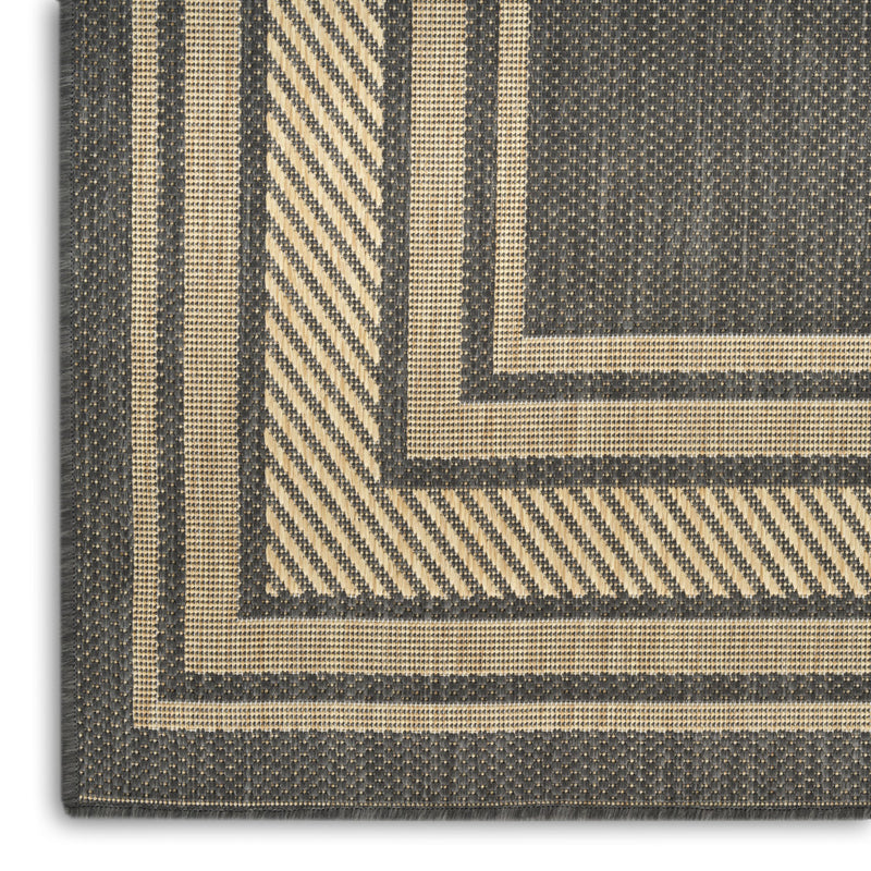 Charcoal geometric area rug edge with striped border and textured woven look