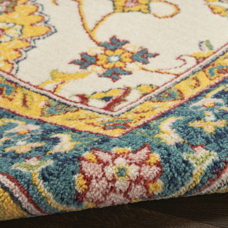 Close-up of ivory and gold floral rug edge with multicolor border detail