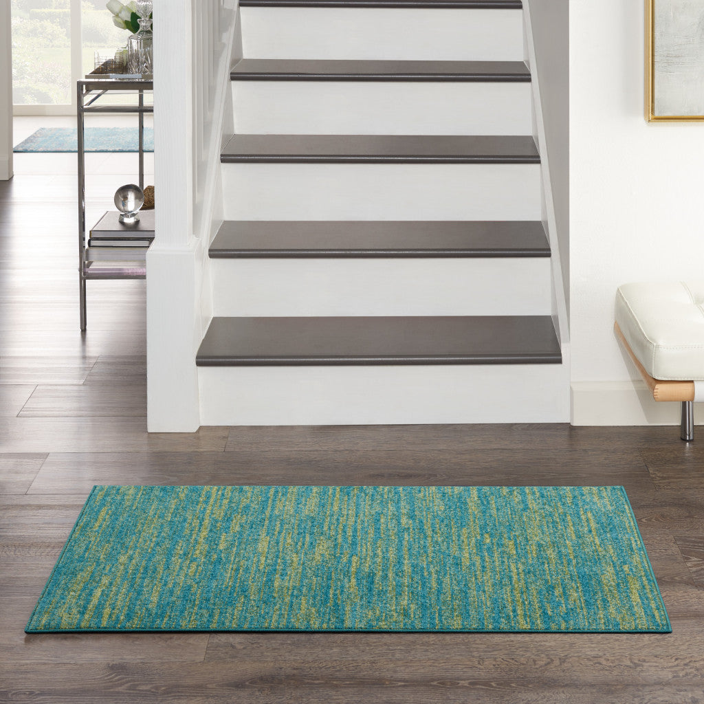 Turquoise and teal patterned indoor rug made of durable fibers, perfect for entryways or living spaces.