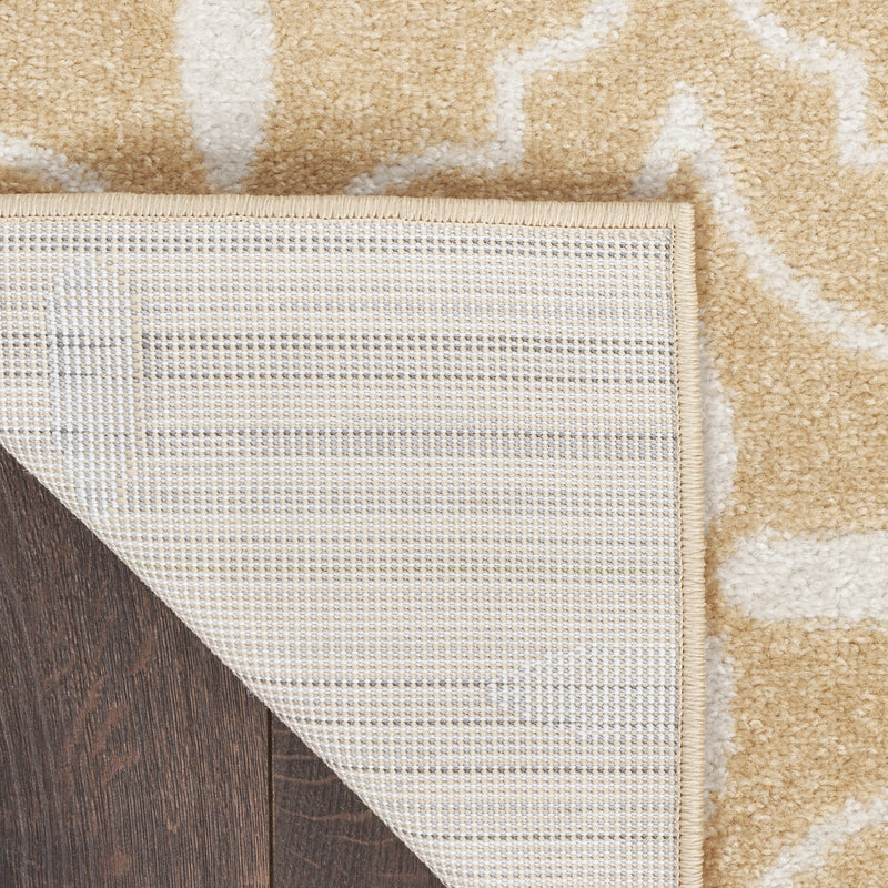 Beige and ivory area rug edge with stitched border; textured low-pile surface.
