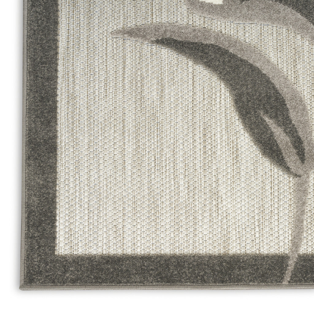 Beige floral area rug with dark border and leaf-and-petal motif
