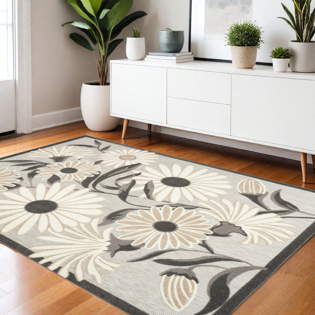 Beige floral area rug spread on hardwood floor with dark border and blossoms