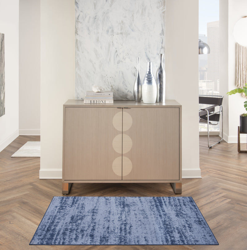 Blue abstract area rug in a living space setting on wood floor
