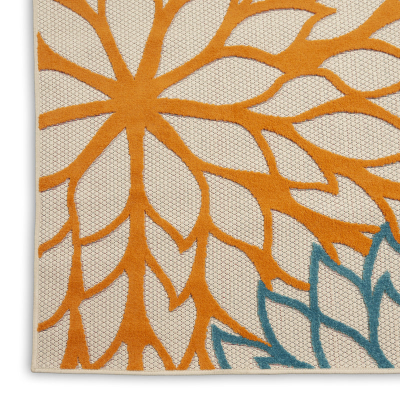 Floral runner rug close-up with orange petal design, cream background, and teal line flowers.
