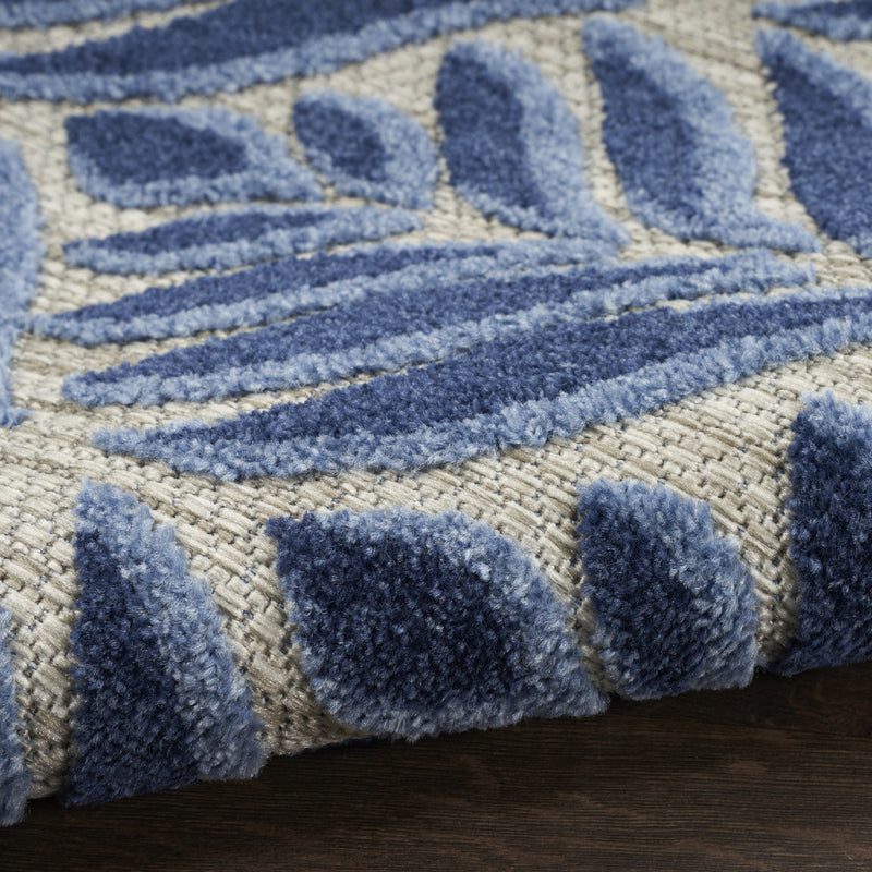 Blue-and-cream rug with looped texture and bold decorative stripes