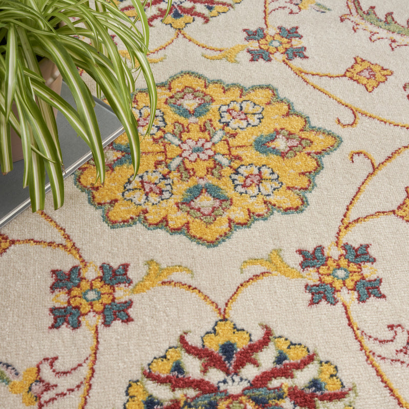 Ivory rug floral section close-up with yellow, blue, and red motif clusters