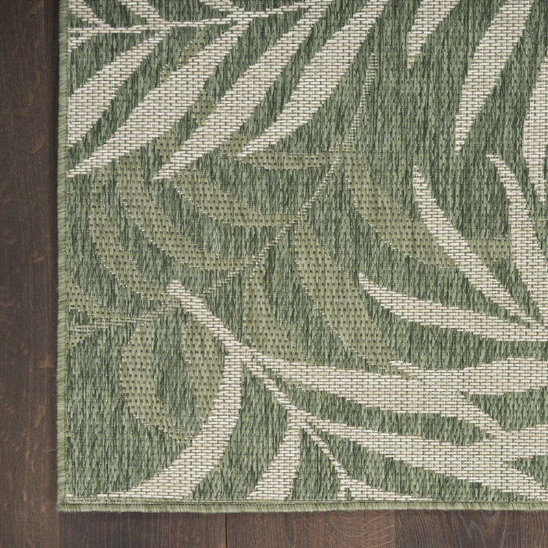 Green and ivory area rug with diagonal palm leaf stripes, stitched woven texture