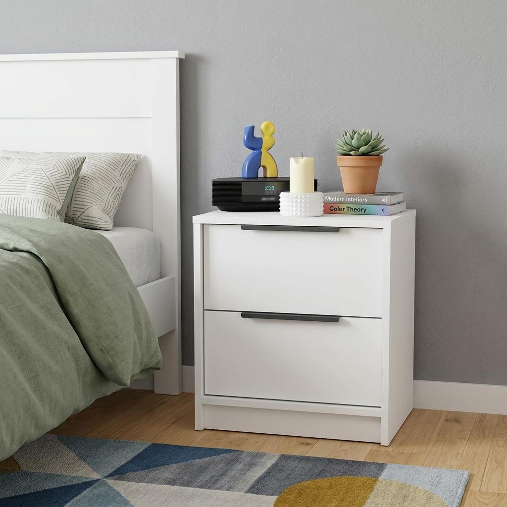 White wood nightstand with two drawers and black bar handles.