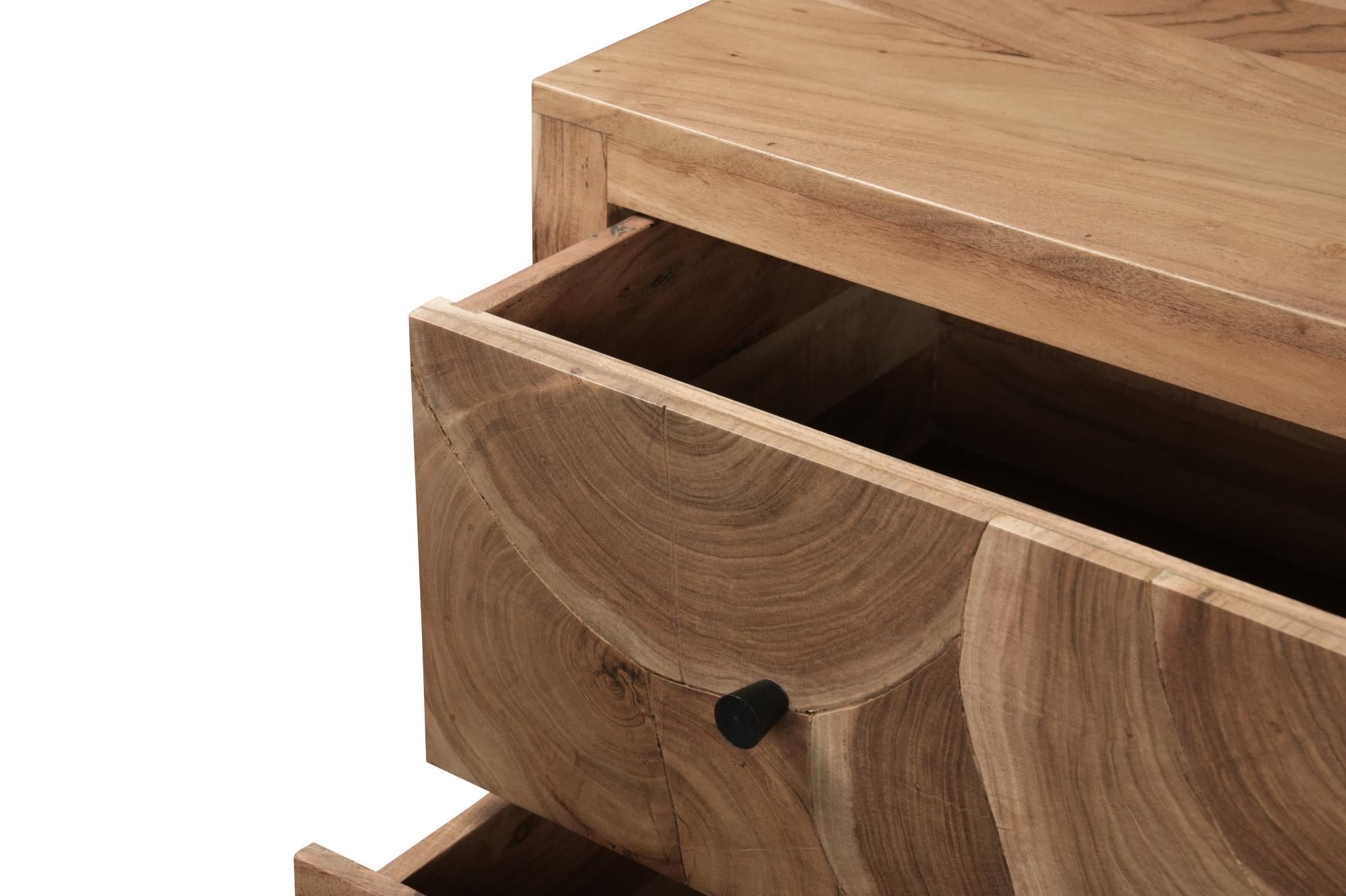 Close-up of brown solid wood dresser drawer with black knob and carved wood grain.