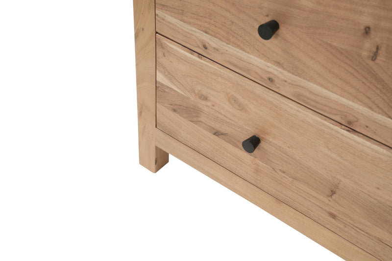 Natural wood five-drawer chest close-up of drawer fronts with black knobs.
