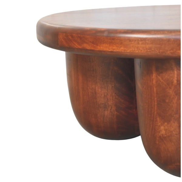 Brown solid wood round coffee table with three drawers, curved apron, rich wood grain.