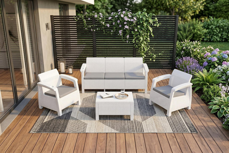 Outdoor patio furniture set with white frames, light gray cushions, and table
