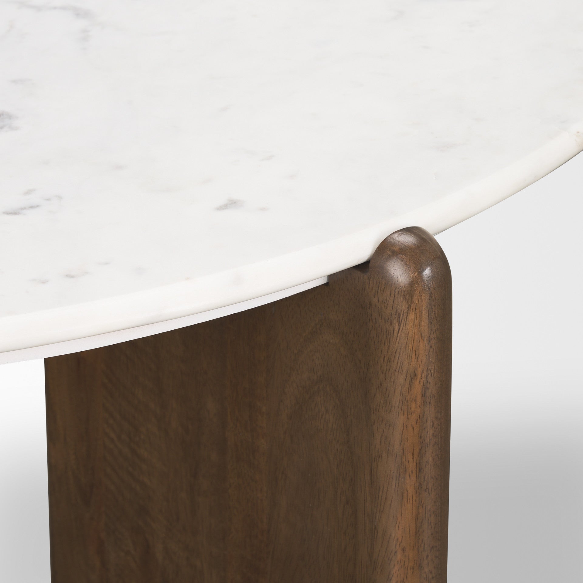 Side view of white marble-look top and dark brown wood corner support