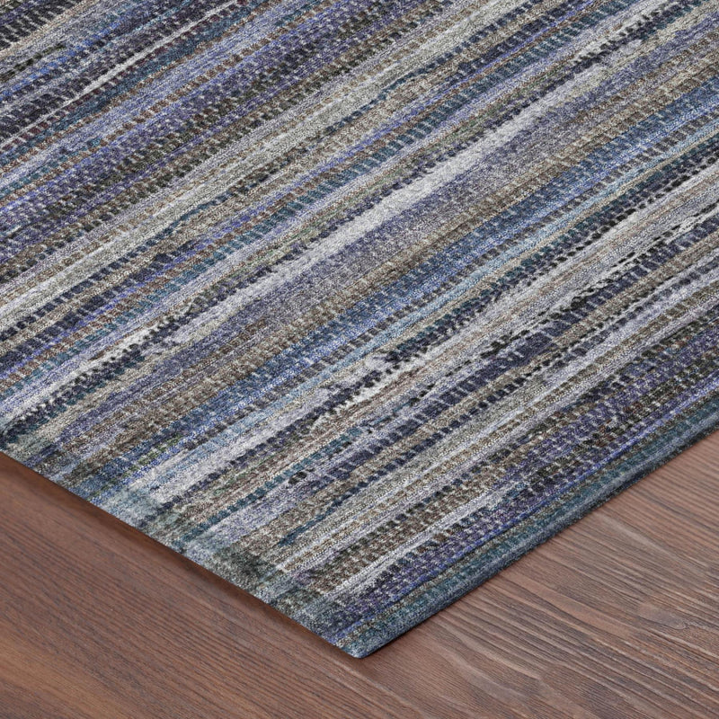 Angled view of blue and beige striped area rug on dark wood floor