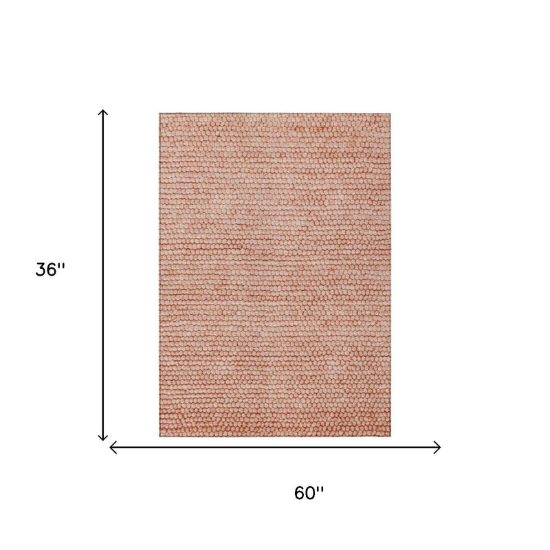 Orange and salmon area rug, 60 in x 36 in, textured pebble pattern